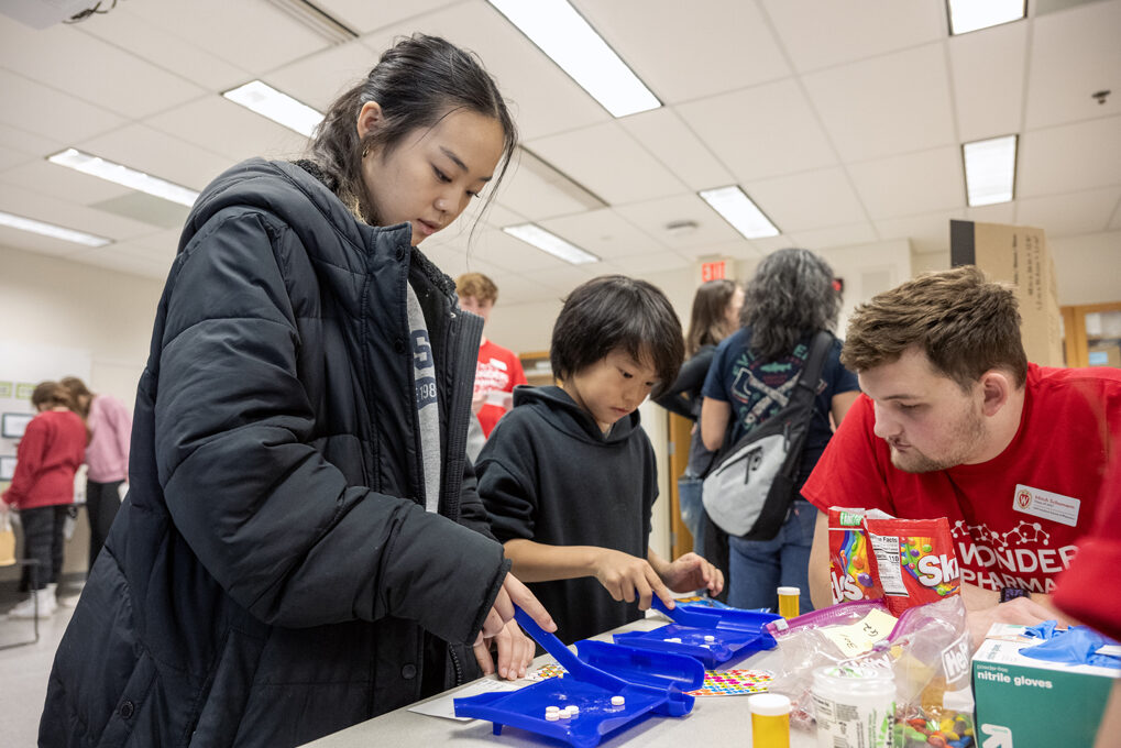 Hailey Vang and her 10-year-old brother Nolan Wang work on separating pills while trying their hands at the Sweet Rx station during the Wonders of Pharmacy on Saturday, March 2, 2024, at the School of Pharmacy on the campus of UW-Madison. (Photo by Paul L. Newby II)