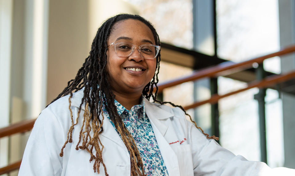 PharmD alum Treashure climbs the stairs to the pharmacy