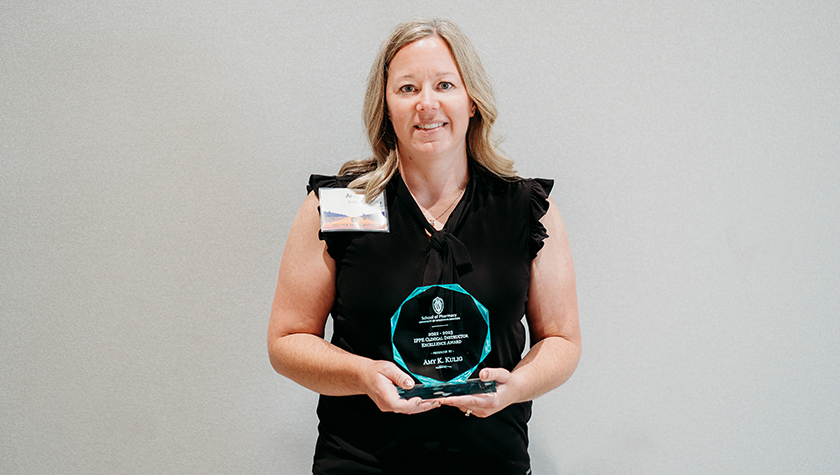 Amy Kulig holding her glass IPPE Clinical Instructor Excellence Award
