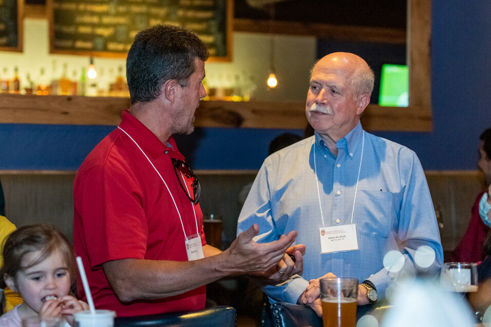 Retired Professor Jim DeMuth chats with Mike Martin