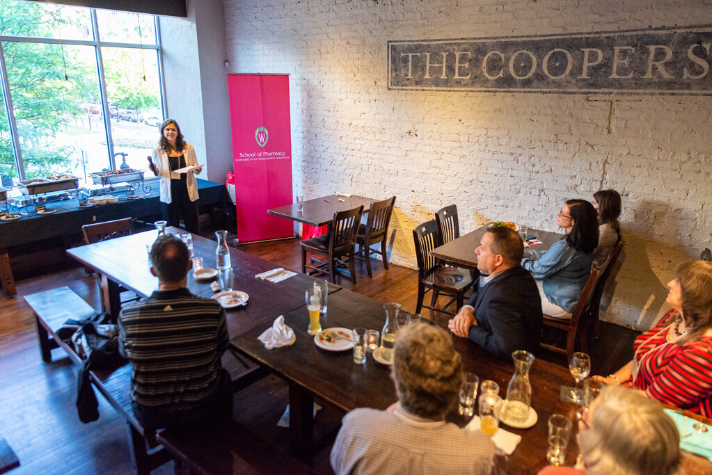 Pharm staff speaking to alumni attendees at Cooper's Tavern