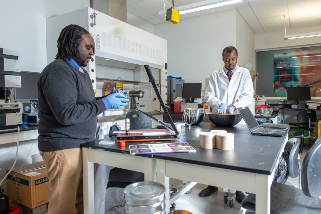 Kwadwo Owusu-Ofori and Walter Matthews creating their product in the lab