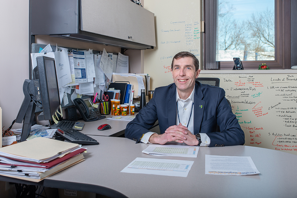 Chris Barron sitting at his desk