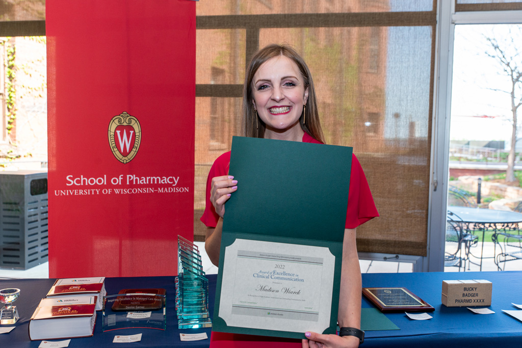 UW Pharm Award recipient holding their award