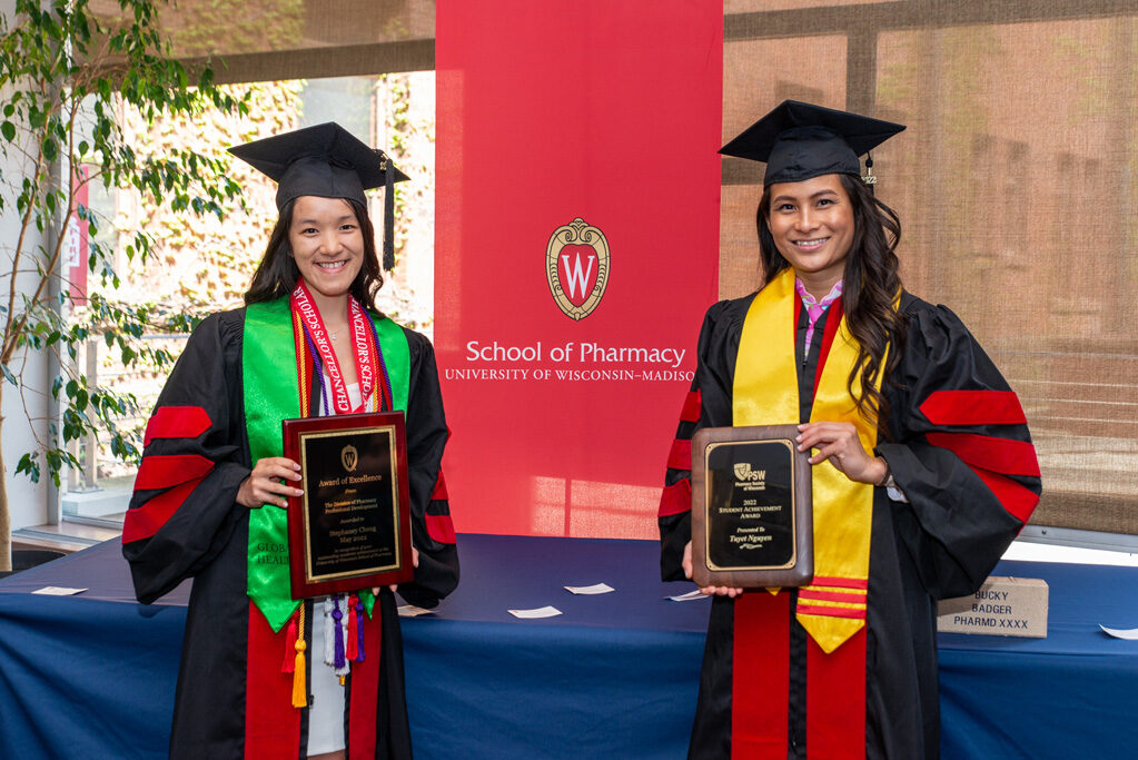 Graduated students holding up their UW Pharm awards