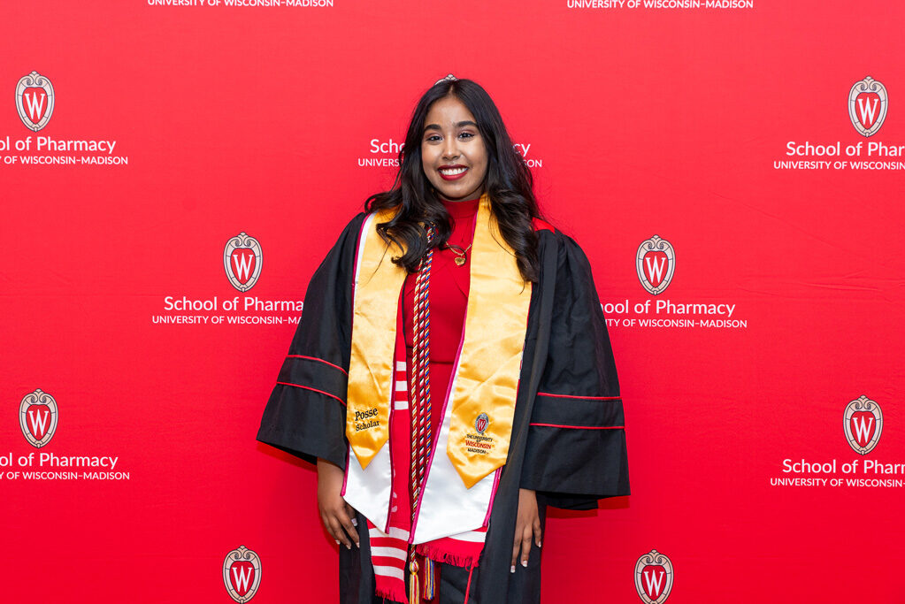 PharmTox Posse Scholar in front of red backdrop
