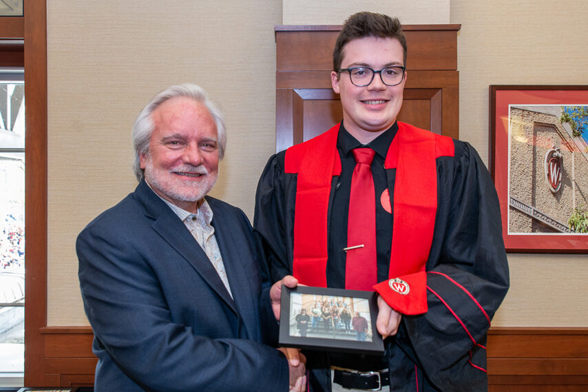 Graduate student with Prof. Jeffrey Johnson holding a picture frame