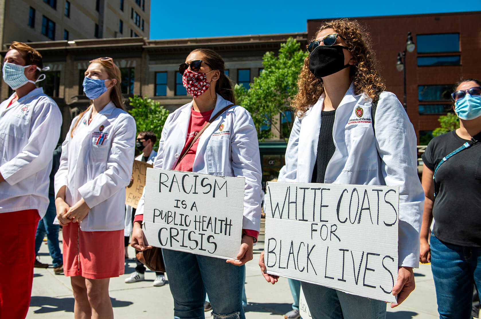 Students holding signs during white coats for black lives march