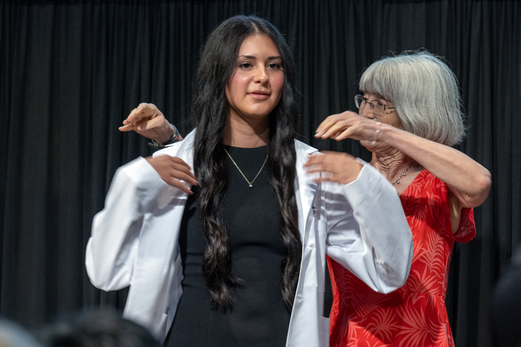 A PharmD student receives her white coat
