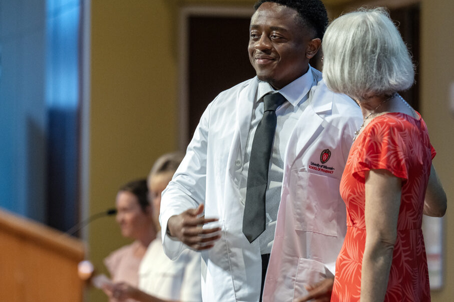 A PharmD student receives his white coat