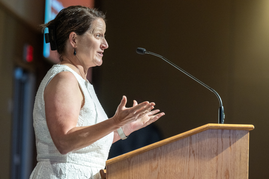 Nicole Schreiner speaks at a podium