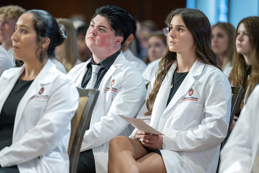 PharmD students sit in their white coats