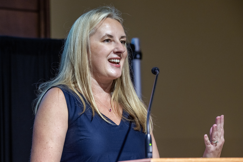Jenny Tempelis speaks into a microphone