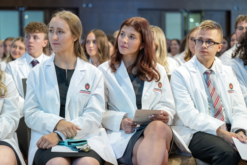 PharmD students sit in white coats