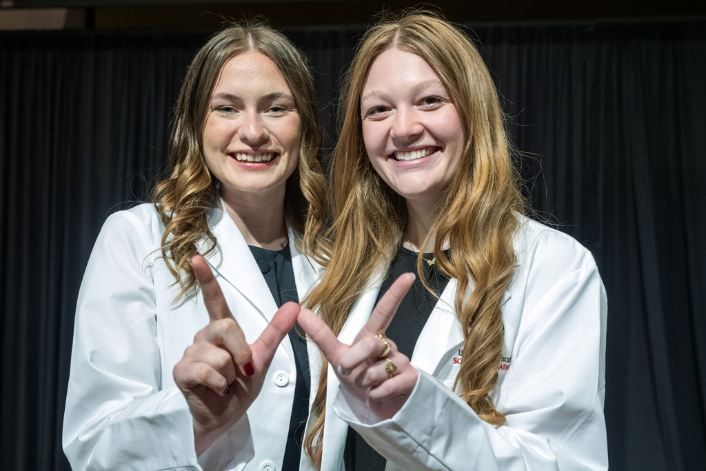 PharmD students pose with their hands in a W