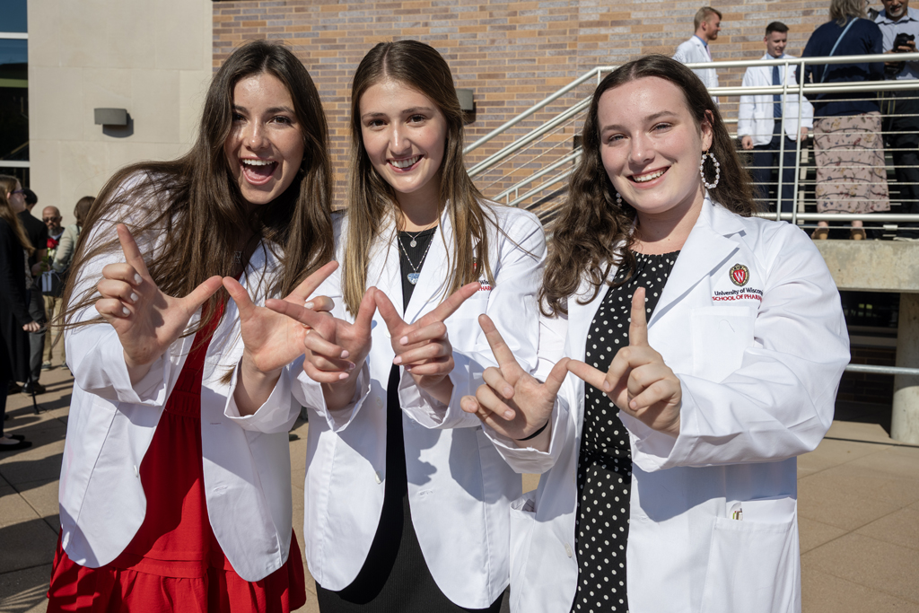 PharmD students pose with their hands in a W