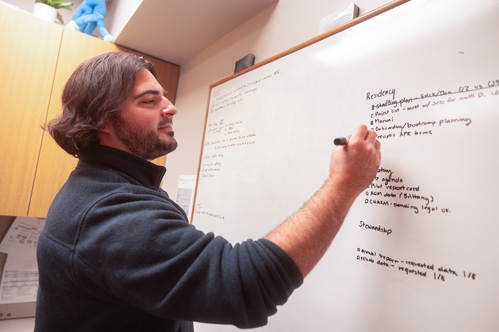 Jake Yandre writing on a whiteboard