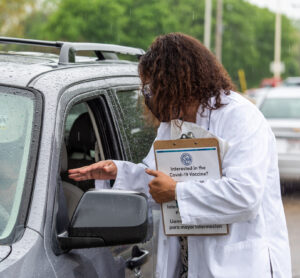 Yolanda Tolson speaking with a patient in a vehicle