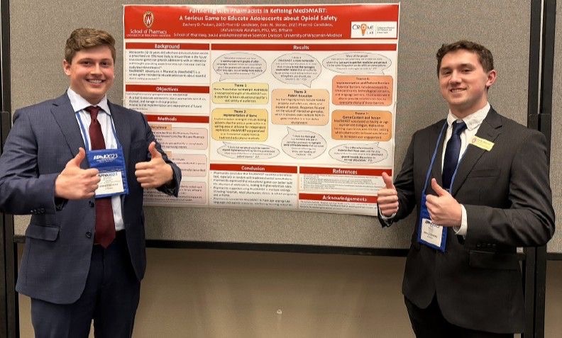 Zachary Paulsen and Evan Slonac presenting research poster at APhA.