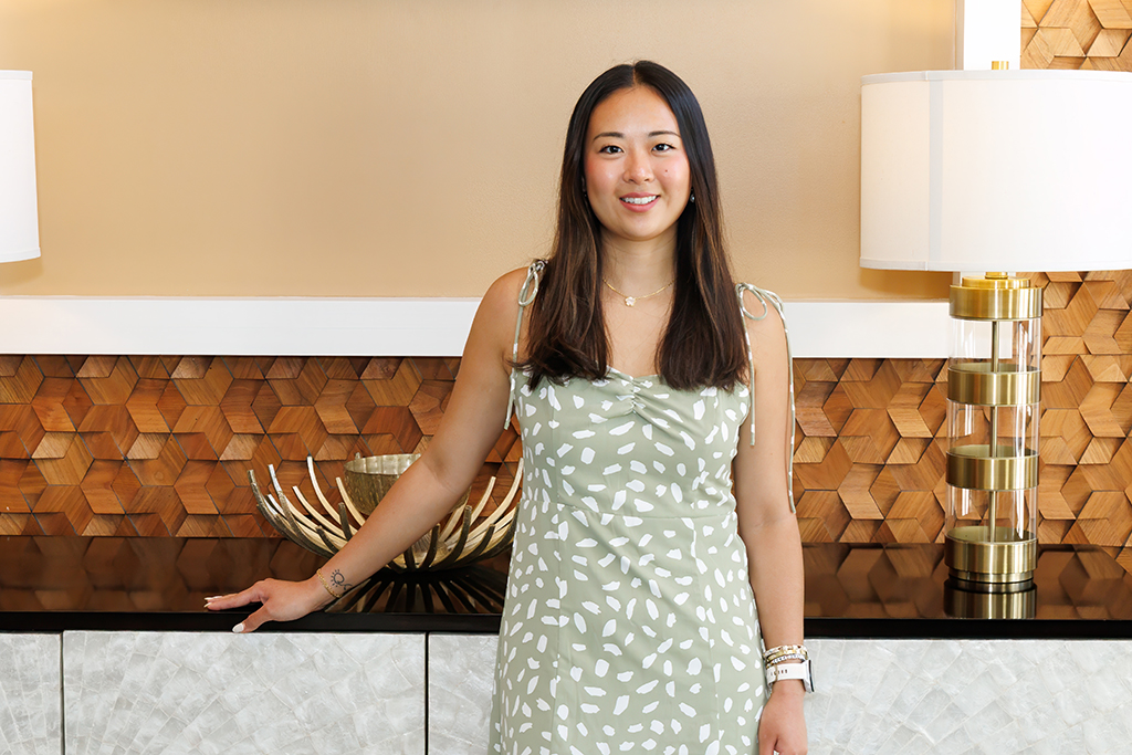 Ziting Zhang portrait near a lamp and brown geometric pattern wall