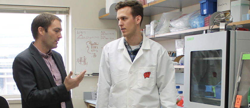 A Pharm-Tox student talks with his faculty research advisor about adjusting their approach to an experiment