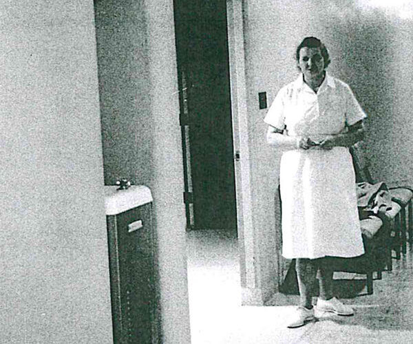Black and white photo of Anna Apinis working as a nurse