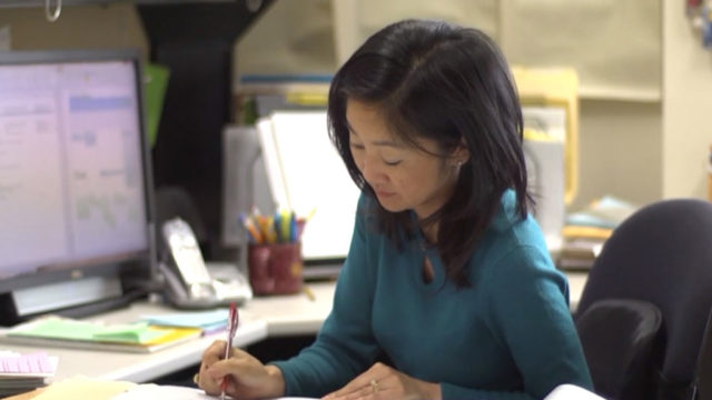 Michelle Chui working at her desk