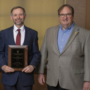 John Davis poses with Dean Steve Swanson following the presentation of his award