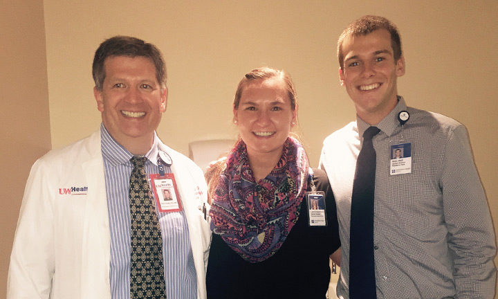 Dr. Patrick Dowling, Laura Josephson, and Alex Hall standing together smiling