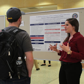 Katherine Beach, DPH-3. (right) shares her research at the annual symposium.