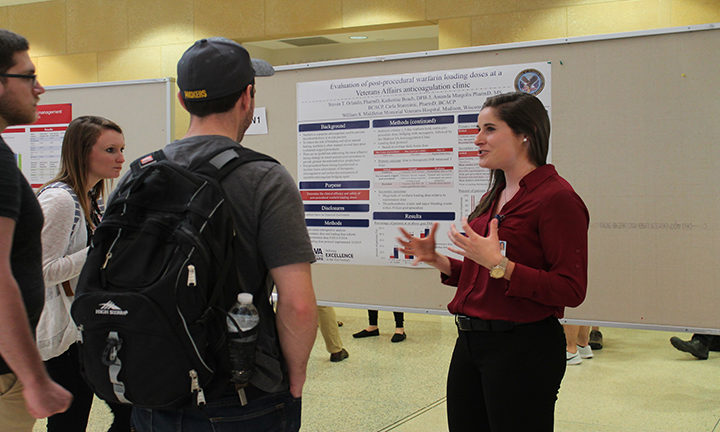 Katherine Beach, DPH-3. (right) shares her research at the annual symposium.