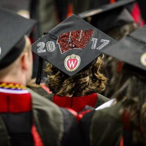 A graduate displays a decorated graduation cap.