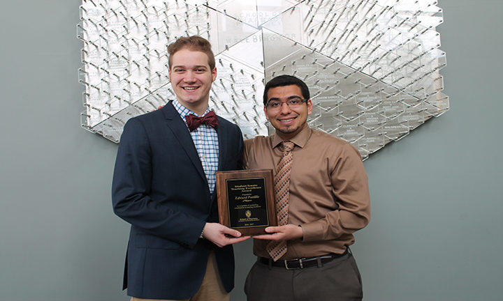 Student Senate Chairperson, Daniel Bruckbauer, DPH-4, (left) presents Edward Portillo, assistant faculty associate in the Pharmacy Practice Division, with the 2016-2017 Student Senate Teaching Excellence Award.