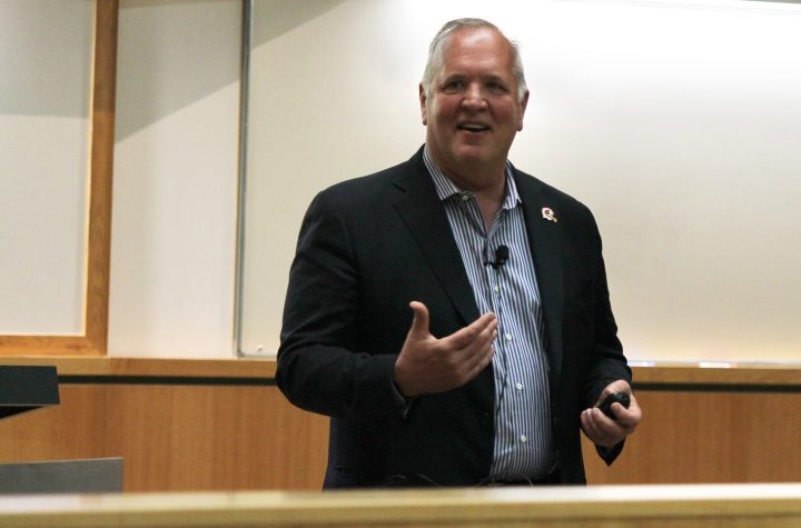 Tom McCourt speaking at front of lecture hall