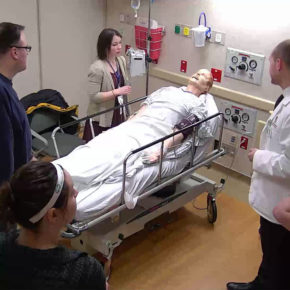 Alex Wontor and interprofessional health care team practicing with fake patient
