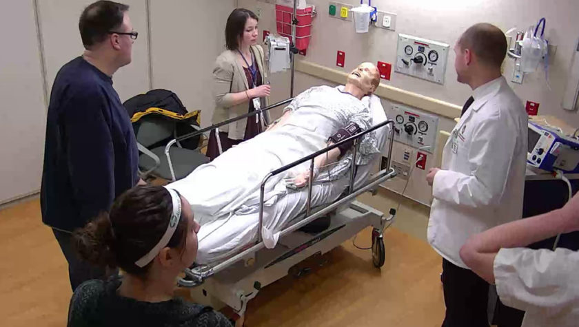 Alex Wontor and interprofessional health care team practicing with fake patient