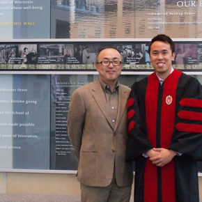 Glen Kwon standing with Tony Tam wearing graduation robes