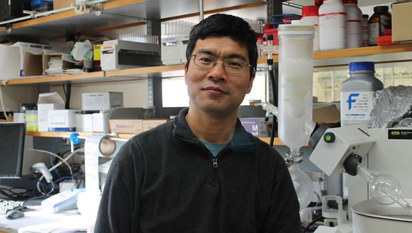 portrait of Weiping Tang in his lab