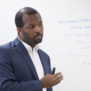 Alumnus Ephrem Abebe speaking in a classroom (MS '14, PhD '16)