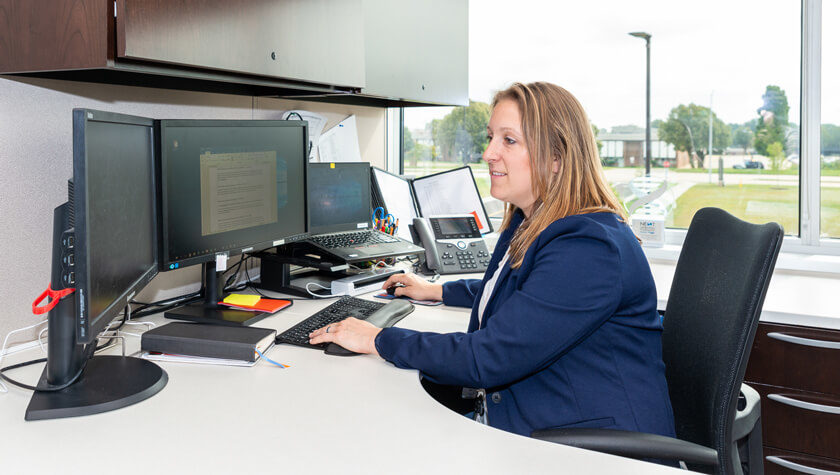 Sharon Faust working at her desk