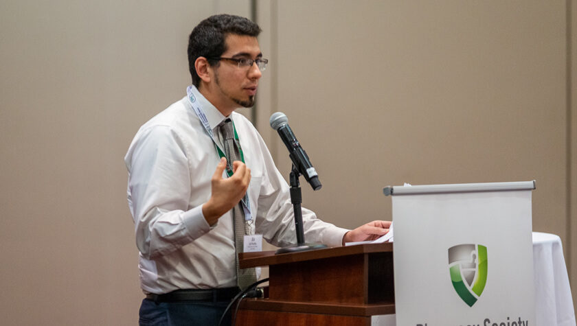 Assistant Professor Ed Portillo at the PSW annual meeting speaking at the podium