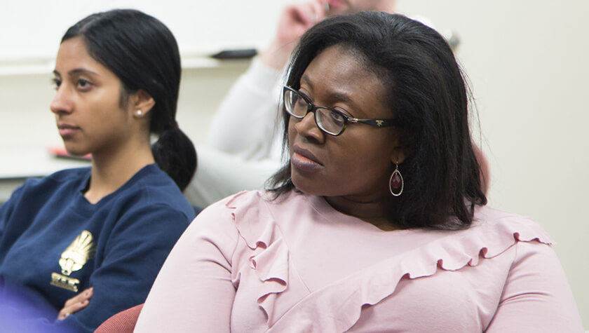 Olayinka Shiyanbola listening to speaker