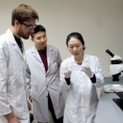 Jiaoyang Jiang working with students in the lab