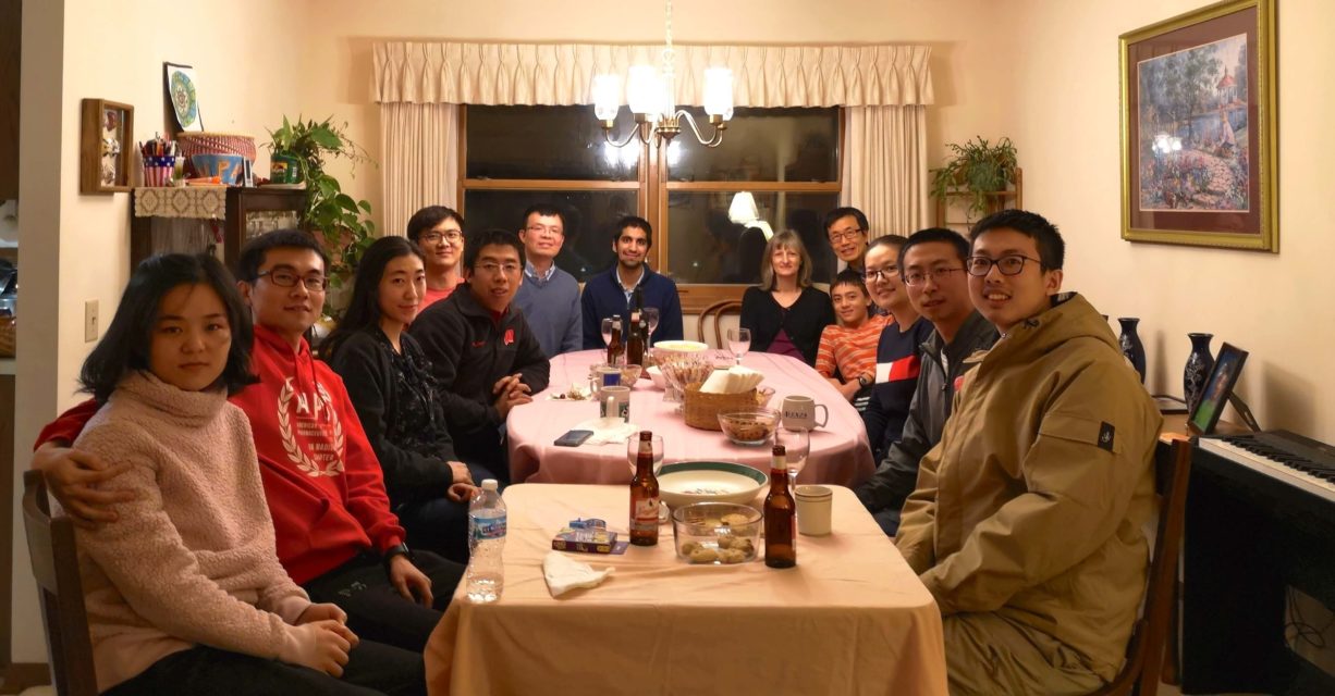 Yu Lab group gathered around a dining table together