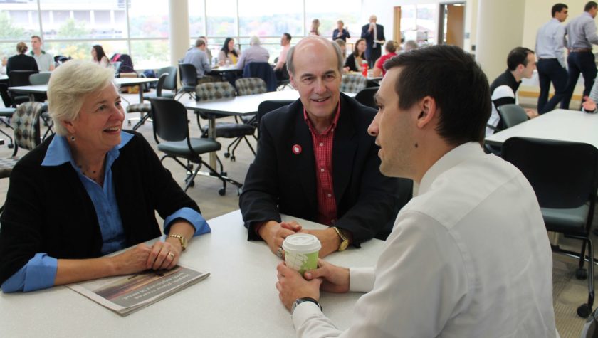 Duane Kirking and his wife sitting at a table with Eric Friestrom