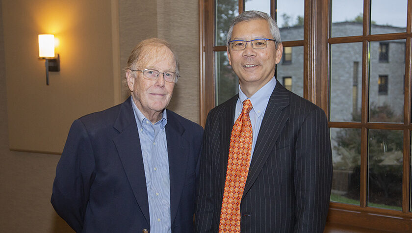 Professor Emeritus Dan Rich standing together with Roger Tung in suits