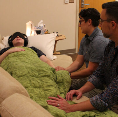 Health practitioners assist a patient during a psilocybin treatment session