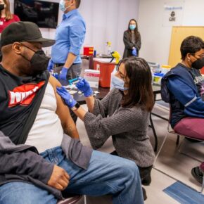 PharmD students Janvi Shah (left) and Kathryn Freitag (right) give the COVID-19 vaccine to a couple at the vaccine clinic held at the McKenzie Family Boys & Girls Club in Sun Prairie. Photo by Paul L. Newby II