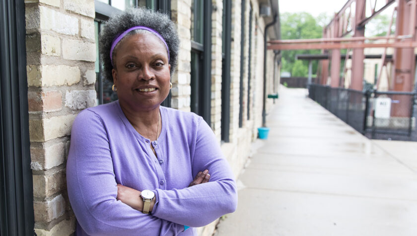 Professor Eva Vivian smiles outside the Goodman Community Center