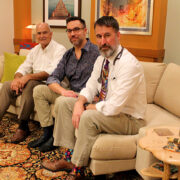 Paul Hutson, Christopher Nicholas, and Randall Brown sitting on a couch together